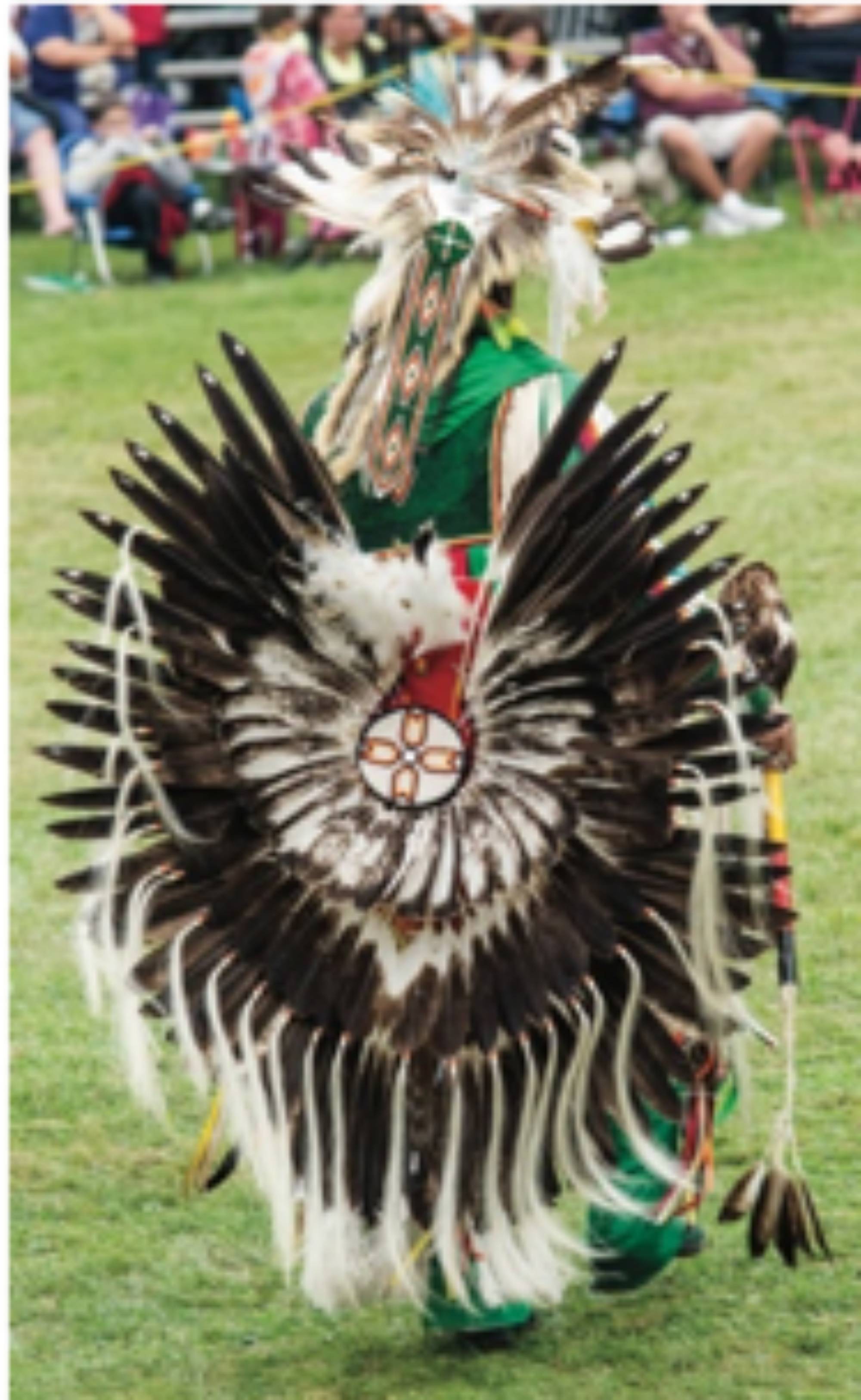 Male dancer wearing traditional grab during a Pow Wow